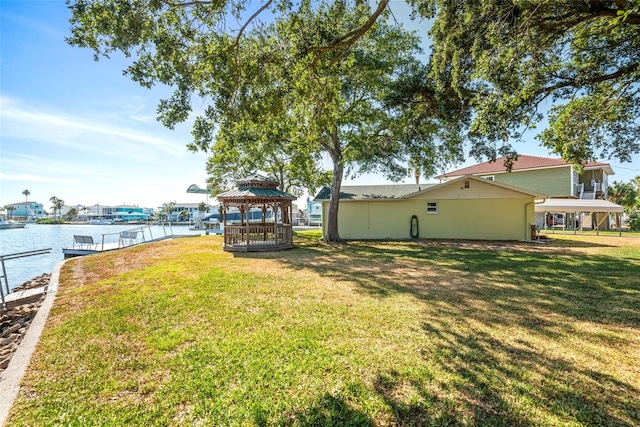 view of yard featuring a gazebo and a water view