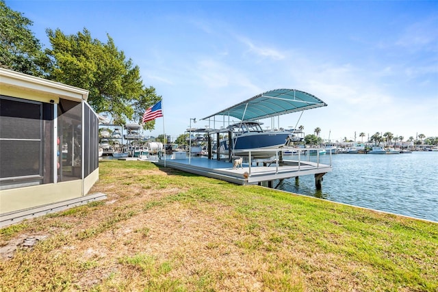 dock area featuring a water view and a lawn