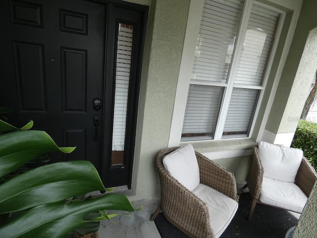 view of exterior entry featuring covered porch