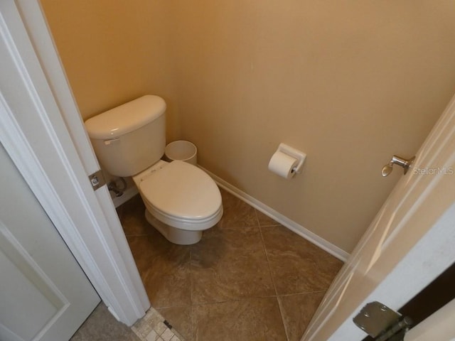 bathroom with tile patterned flooring and toilet