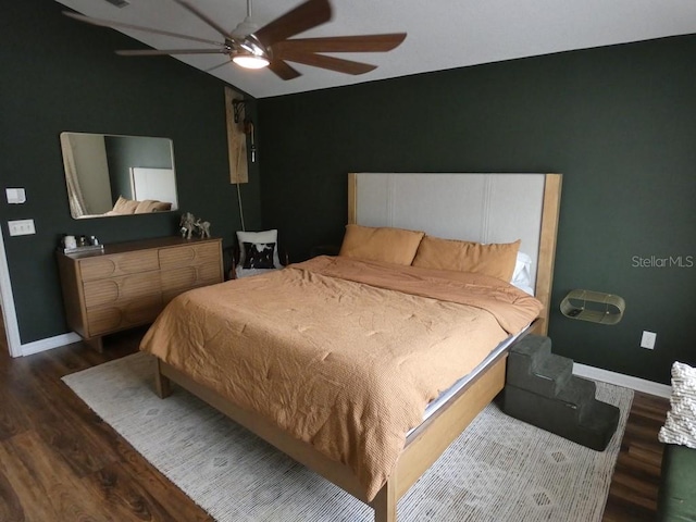 bedroom with dark hardwood / wood-style flooring, ceiling fan, and lofted ceiling