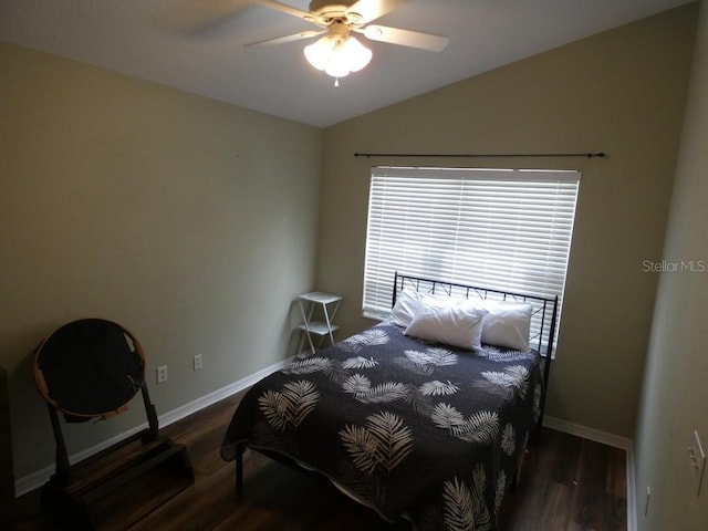 bedroom with ceiling fan, lofted ceiling, and dark wood-type flooring