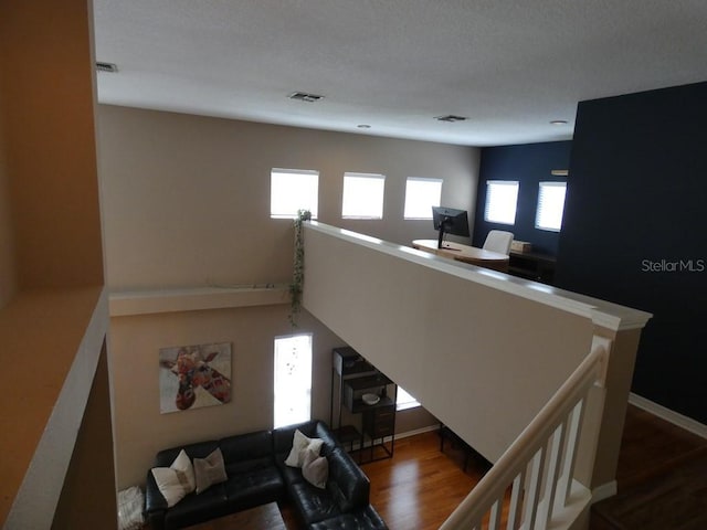 living room featuring a wealth of natural light, a textured ceiling, and hardwood / wood-style flooring