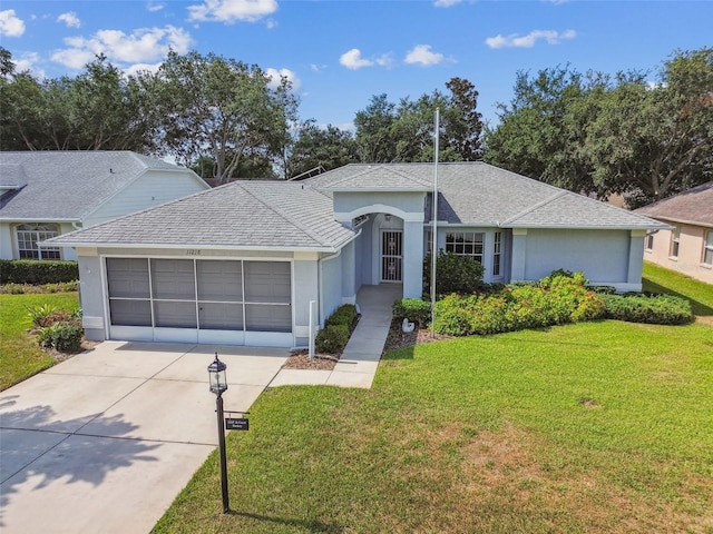 ranch-style home featuring a garage and a front yard