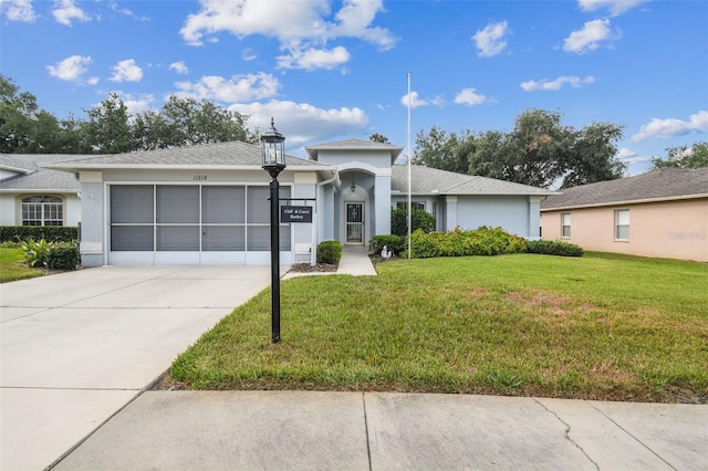 view of front facade featuring a front yard and a garage