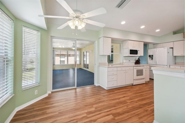 kitchen featuring white cabinetry, white appliances, and light hardwood / wood-style flooring