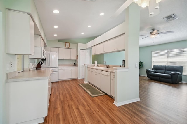 kitchen featuring white cabinetry, dishwasher, light hardwood / wood-style floors, and sink