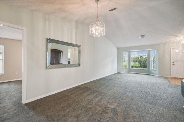 unfurnished living room featuring dark colored carpet, lofted ceiling, and an inviting chandelier