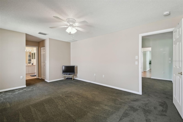 unfurnished living room with dark colored carpet, ceiling fan, and a textured ceiling