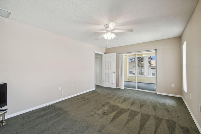 carpeted empty room with ceiling fan and a textured ceiling