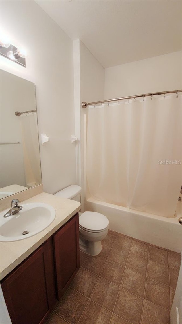 bathroom with toilet, shower / tub combo with curtain, and vanity