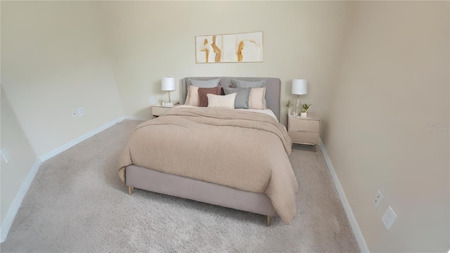 bedroom with light carpet and baseboards