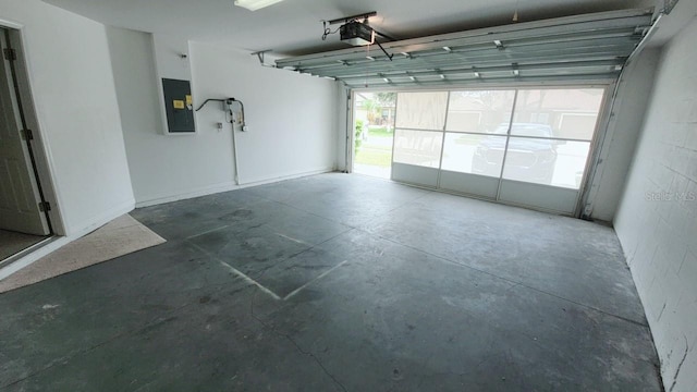 garage with a garage door opener and electric panel