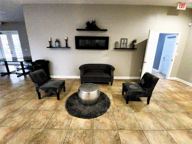 sitting room with tile patterned floors and baseboards