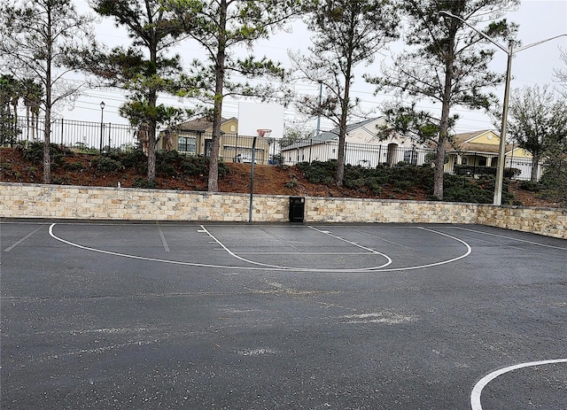 view of basketball court with community basketball court and fence