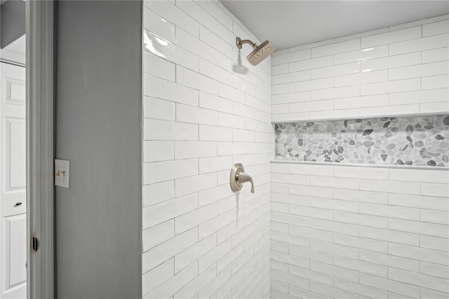 bathroom with a tile shower