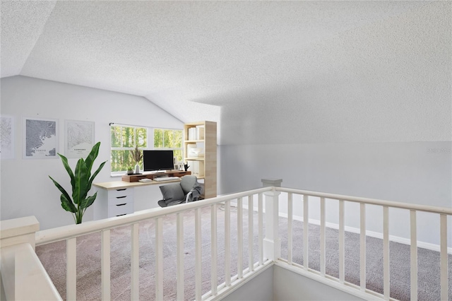 staircase featuring carpet flooring, a textured ceiling, and vaulted ceiling