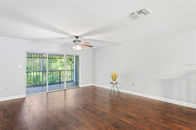 unfurnished room featuring a textured ceiling, ceiling fan, and dark wood-type flooring