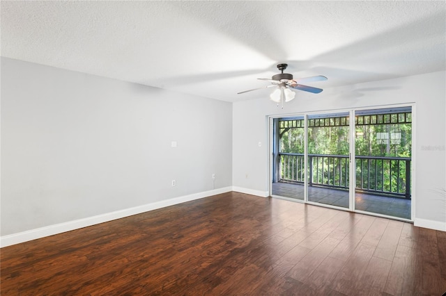 empty room with a textured ceiling, ceiling fan, and dark hardwood / wood-style floors