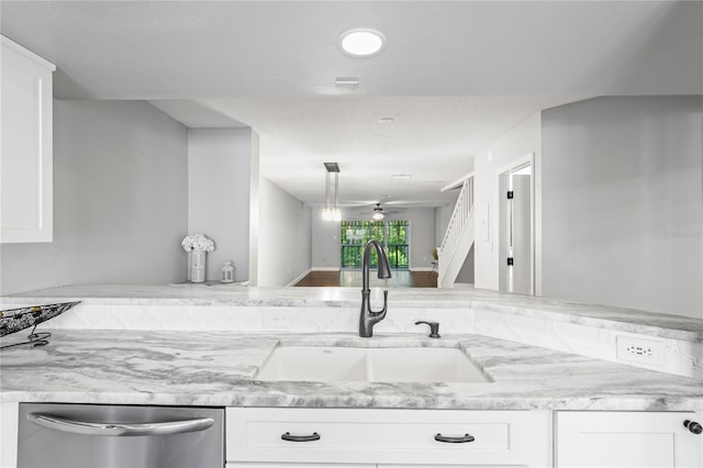 kitchen with sink, kitchen peninsula, stainless steel dishwasher, ceiling fan, and white cabinetry