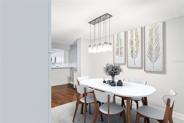 dining area featuring hardwood / wood-style floors and a textured ceiling