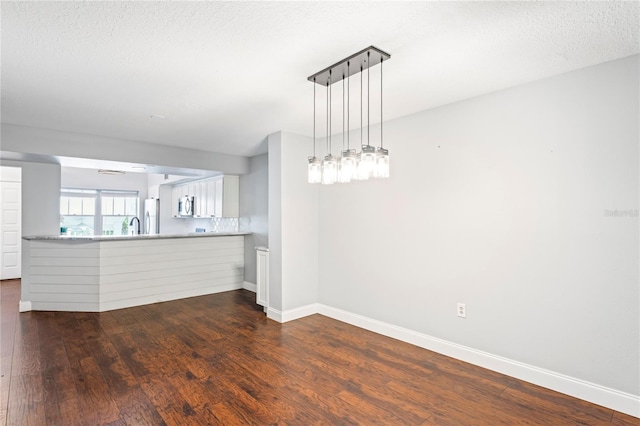 interior space with dark hardwood / wood-style floors and a textured ceiling