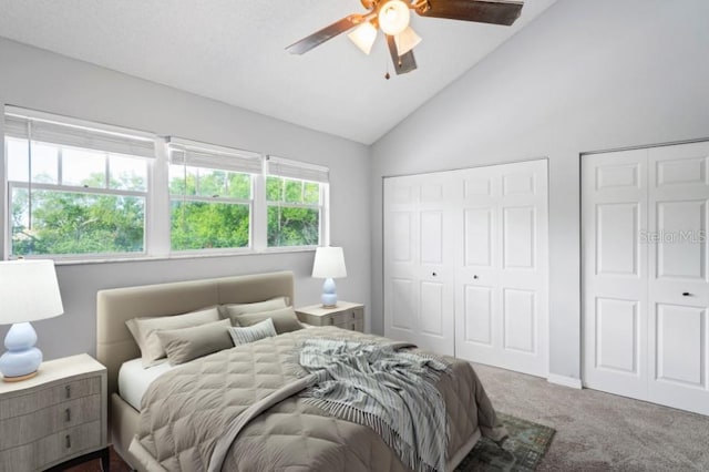 bedroom featuring carpet, ceiling fan, lofted ceiling, and multiple closets