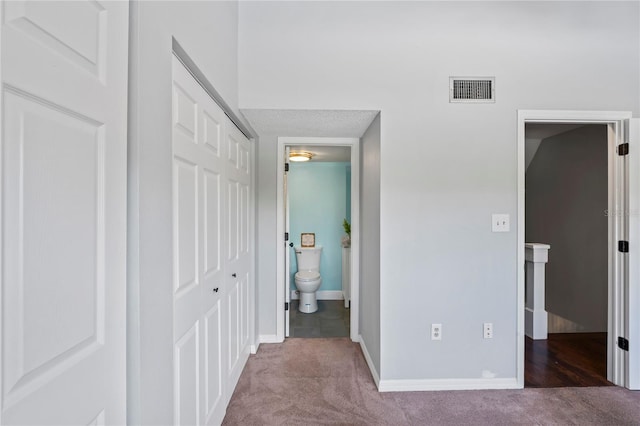 hall featuring light colored carpet