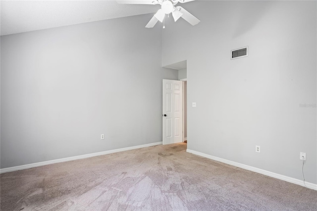 unfurnished room featuring a high ceiling, carpet floors, and ceiling fan