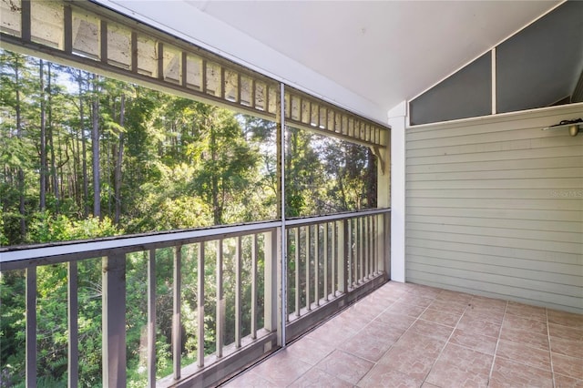 unfurnished sunroom with a wealth of natural light and vaulted ceiling