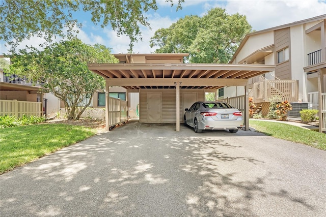 view of parking / parking lot featuring a yard