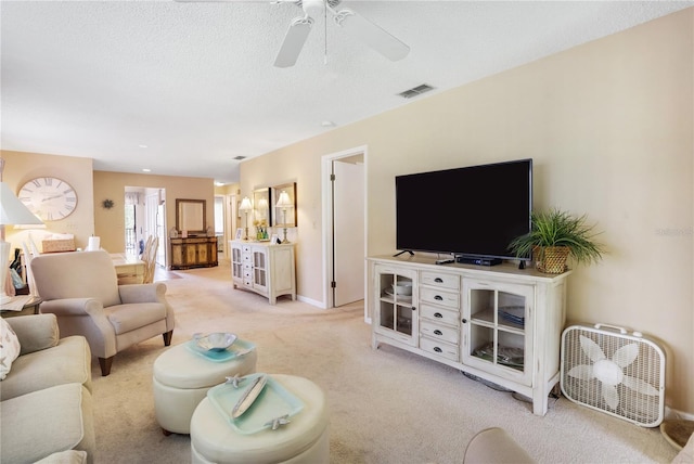 living room featuring ceiling fan and light colored carpet