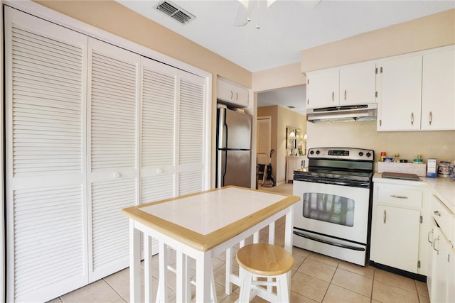 kitchen with white cabinetry, stainless steel appliances, and light tile patterned flooring