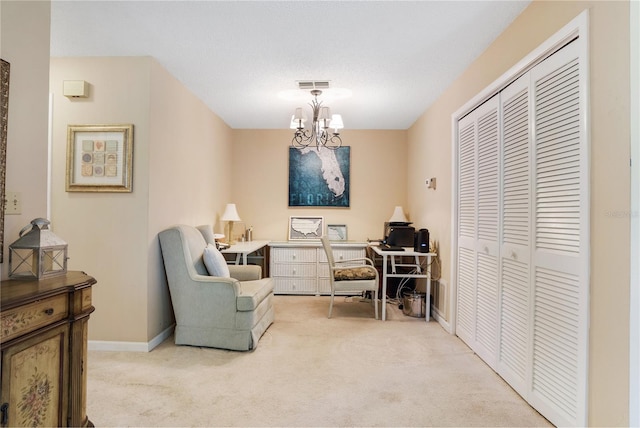 sitting room with an inviting chandelier and light colored carpet