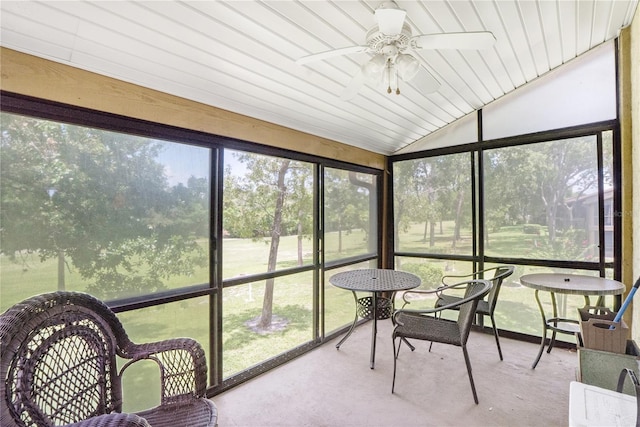 sunroom / solarium with ceiling fan and vaulted ceiling