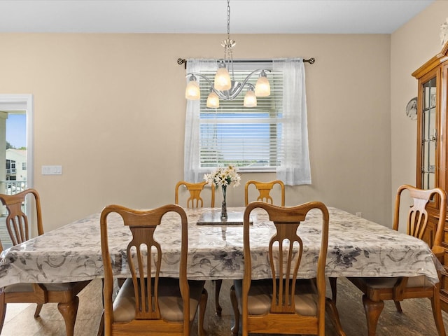 dining area with an inviting chandelier