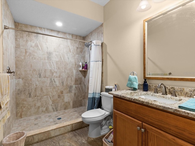 bathroom with a shower with shower curtain, vanity, and toilet