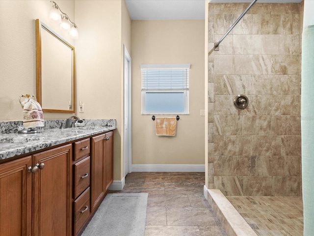 bathroom featuring vanity and tiled shower