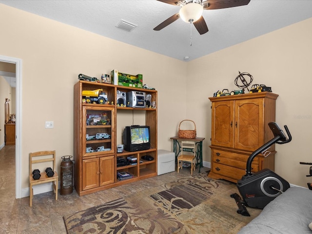 workout room with ceiling fan