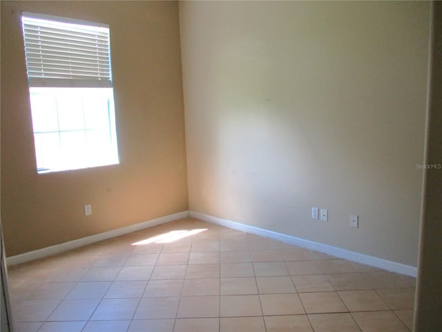 unfurnished room featuring light tile patterned floors