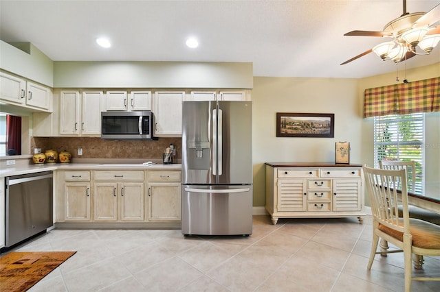 kitchen featuring ceiling fan, light tile floors, tasteful backsplash, and appliances with stainless steel finishes