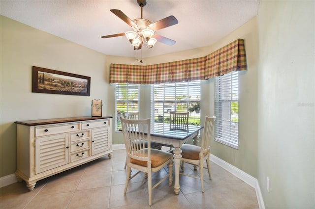 tiled dining space featuring ceiling fan