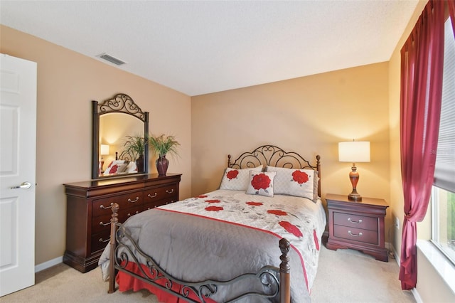 bedroom featuring light carpet