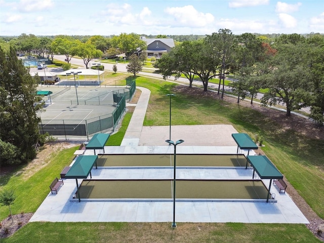 surrounding community featuring a yard and tennis court