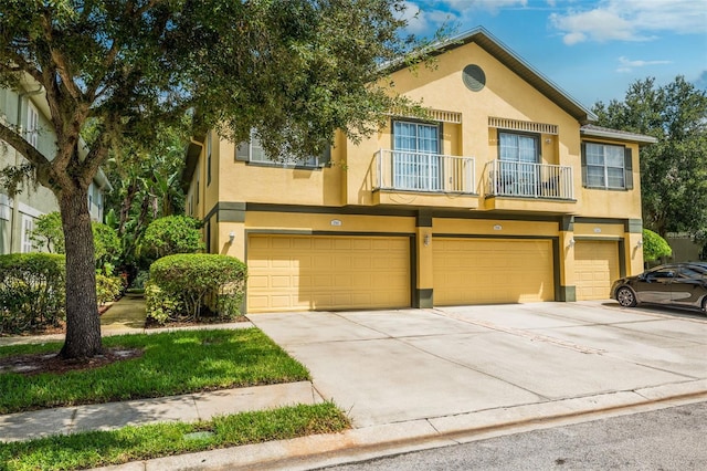 view of property featuring a balcony and a garage