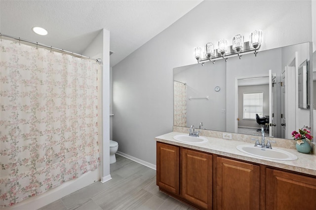 bathroom with a shower with curtain, vanity, and toilet