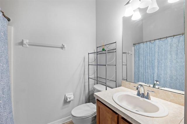 bathroom featuring vanity, a shower with shower curtain, and toilet