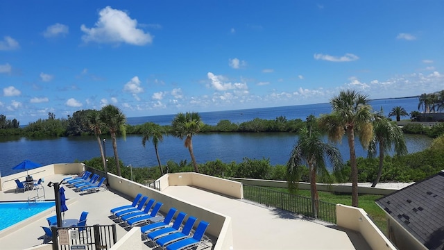 view of patio / terrace with a community pool and a water view