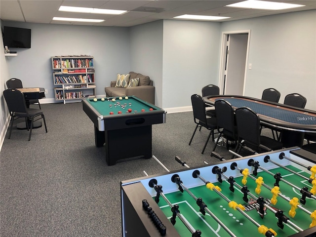 recreation room with a paneled ceiling and carpet