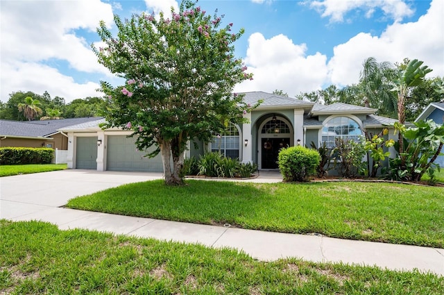 view of front of house with a front yard and a garage